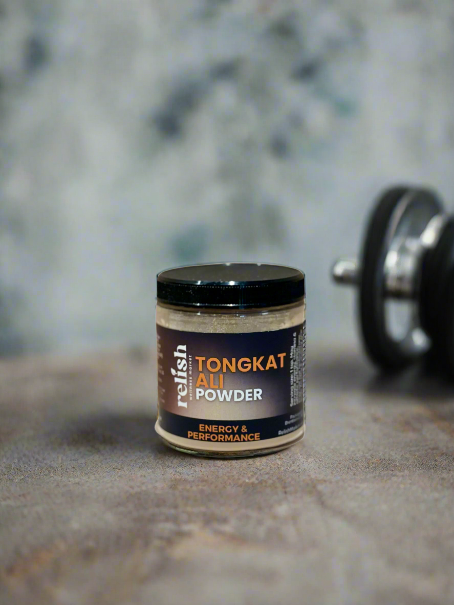 a jar of Tongkat Ali powder on a textured base with textured blue background. Also a hand weight in the background.