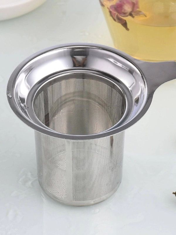 Metal tea infuser on a light background