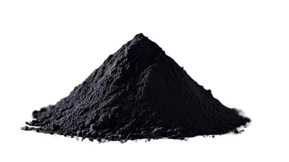 A mound of activated charcoal powder on a white background.