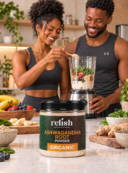 A man and a woman making a smoothie in a kitchen using a jar of Relish Wellness Market Organic Ashwagandha Root Powder, featuring a black lid and a dark green and orange label.