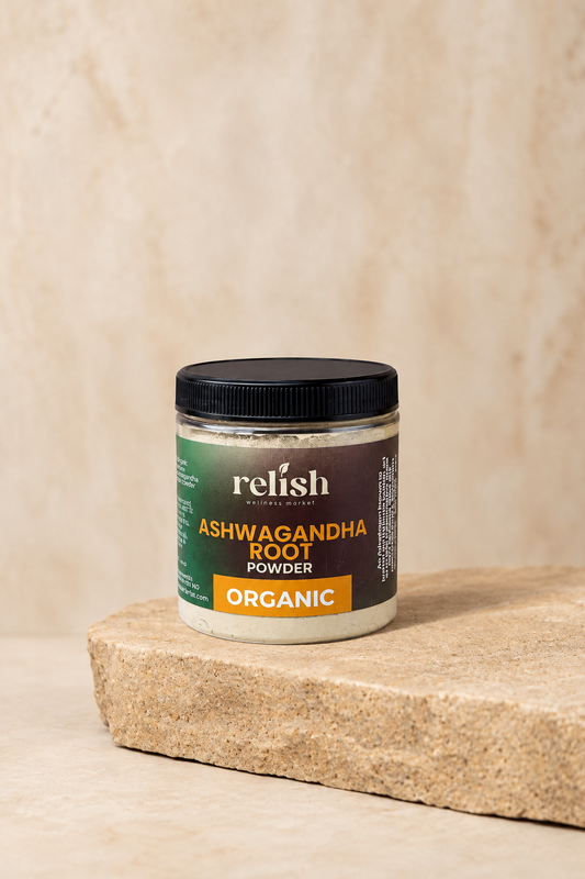 A jar of Relish Ashwagandha Root Powder Organic, placed on a light stone slab against a textured beige background.
