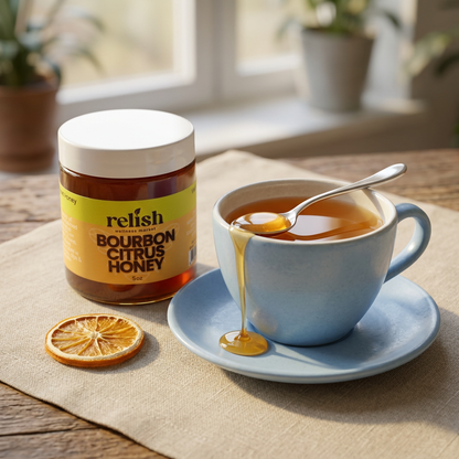 Bourbon Citrus Honey by Relish Market with a brewed cup of tea and honey serving scene.