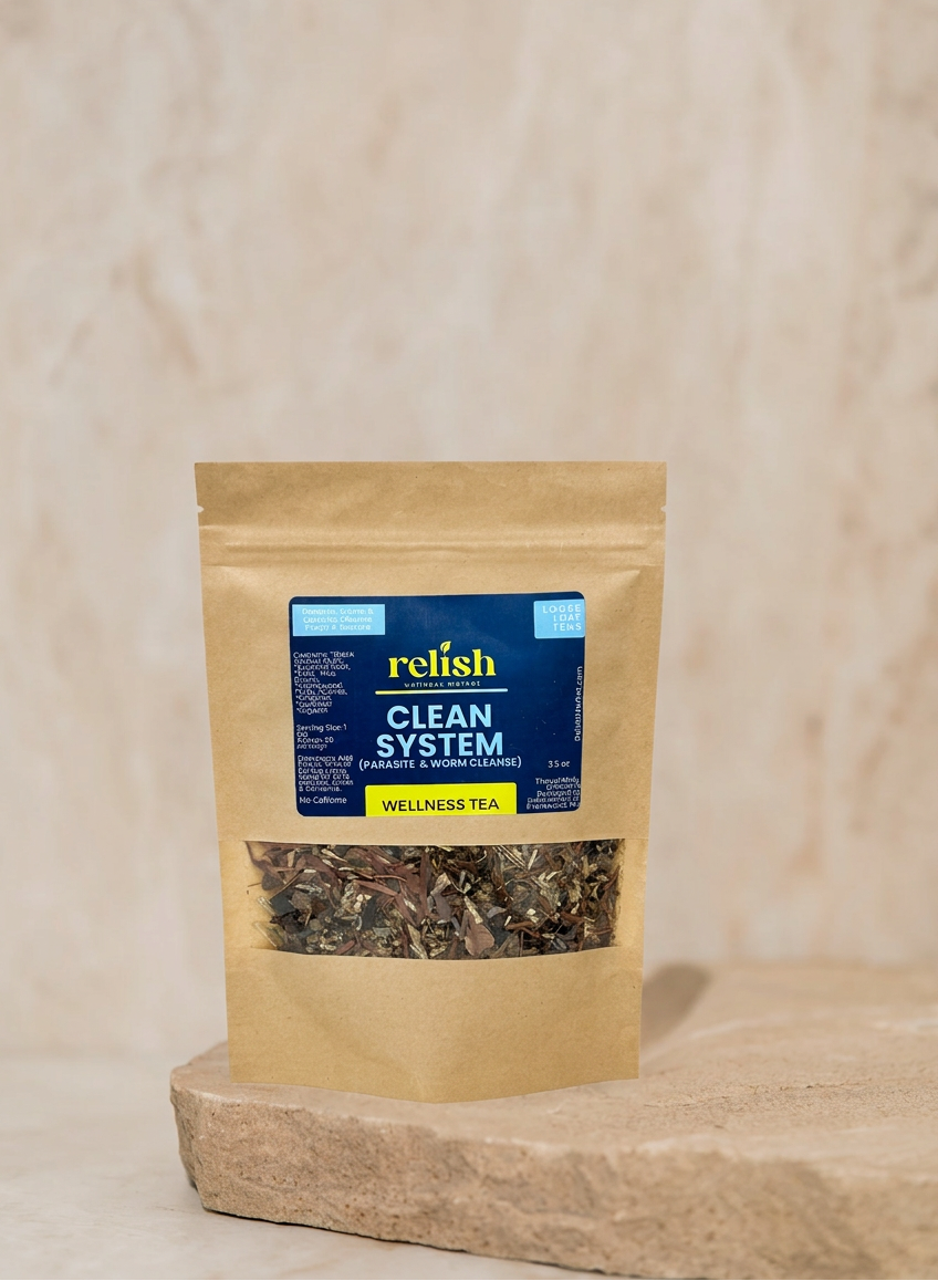 A stand-up kraft paper pouch of Relish Market Clean System Wellness Tea with a clear window showing loose tea leaves, set on a stone slab against a textured beige background.
