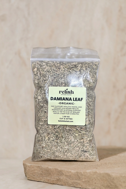 Clear zip bag of Organic Damiana Leaf by Relish Market on a stone slab and neutral textured background