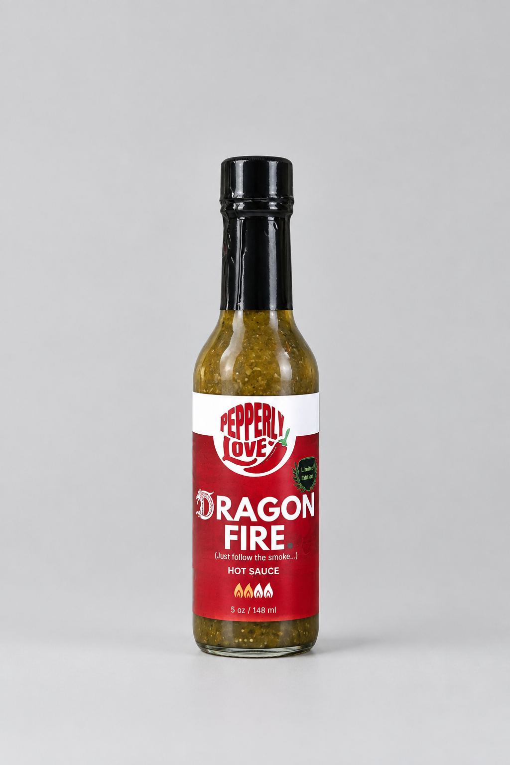 A bottle of Peppery Love Dragon Fire hot sauce on a light grey background.