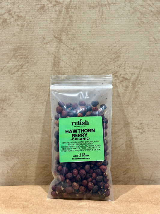 Packaged hawthorn berries with a green label on a wooden surface