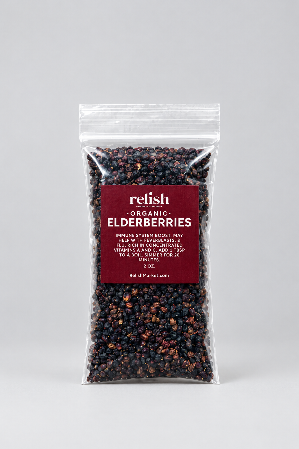 A clear stand-up resealable pouch filled with dark elderberries, with a large dark red front label reading 'Relish Market ORGANIC ELDERBERRIES,' photographed on a light gray studio background.