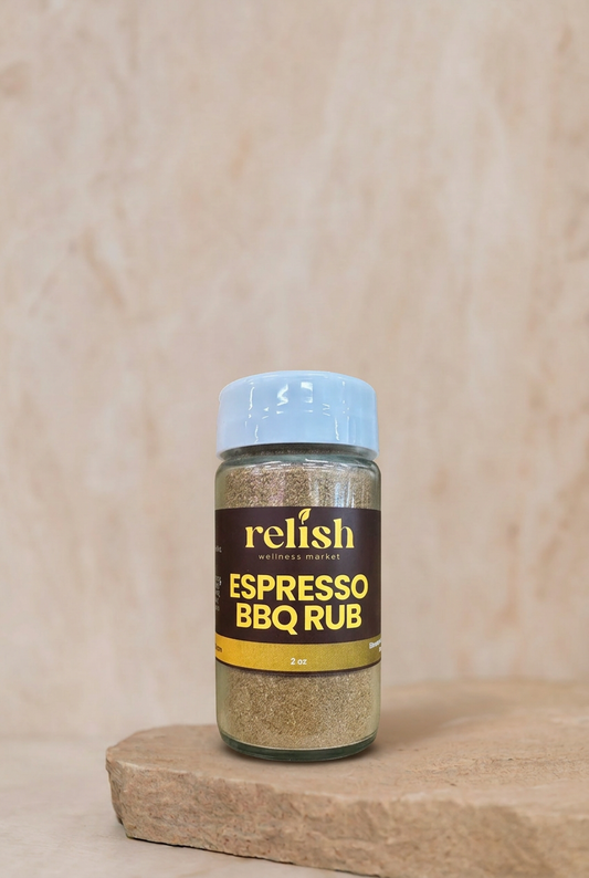 A bottle of Relish Market Espresso BBQ Rub seasoning rub on a stone slab against a neutral beige background.