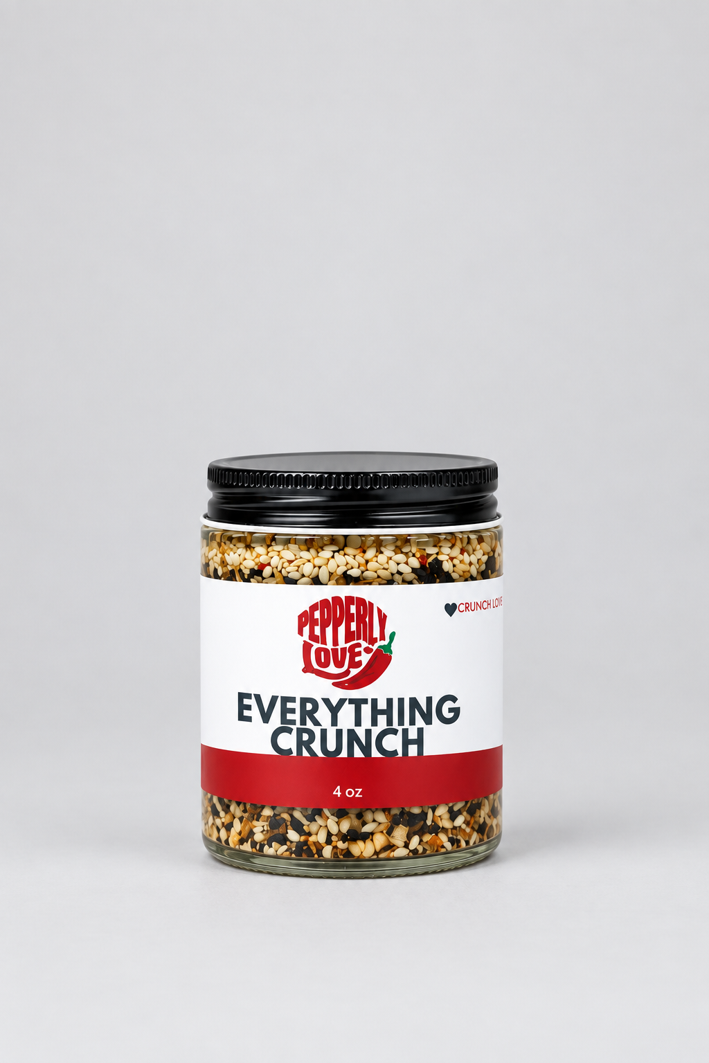 A 4 oz glass jar of Pepperly Love Everything Crunch mix with a black lid and white label, set against a clean light gray background.