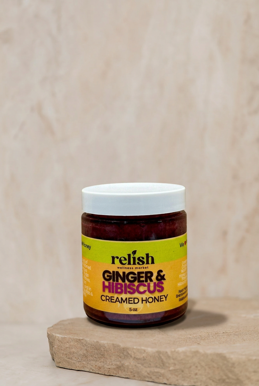 Ginger & Hibiscus Creamed Honey by Relish Market on a stone slab with a neutral background.