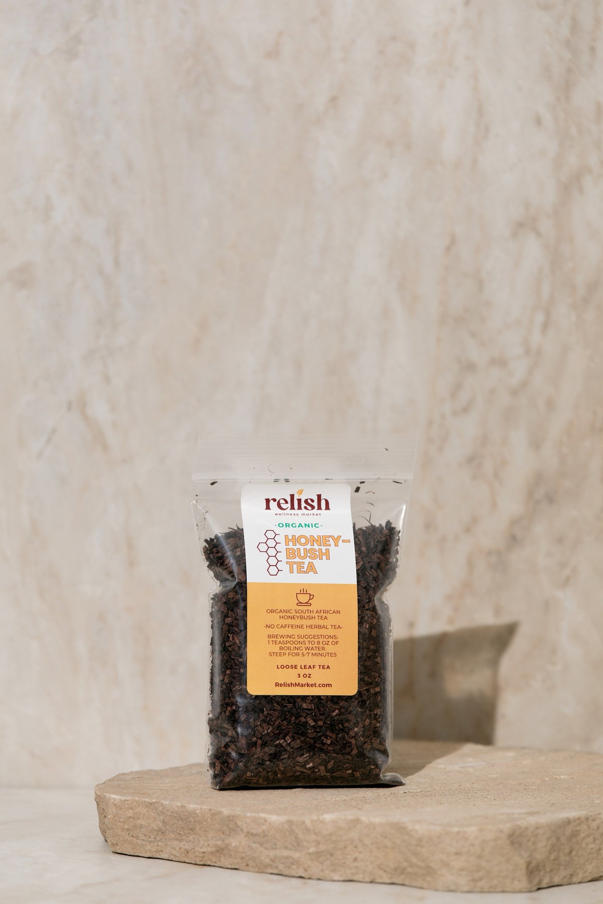 Packaged Honeybush Tea by Relish Market on a stone surface with a neutral background