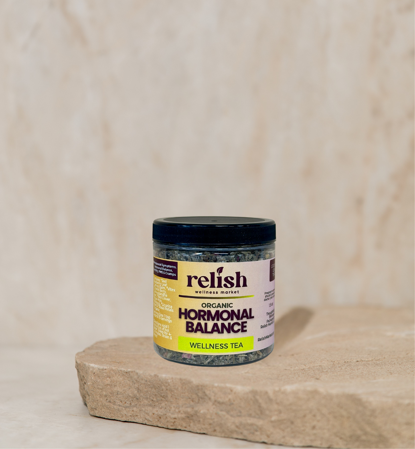 Jar of 'Relish' Hormonal Balance Wellness Tea on a wooden surface with a beige background