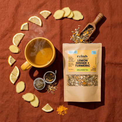 Lemon Ginger Turmeric Tea Blend by Relish Market brewing flat-lay with ingredients including lemon ginger and turmeric on a Sienna cloth like background.