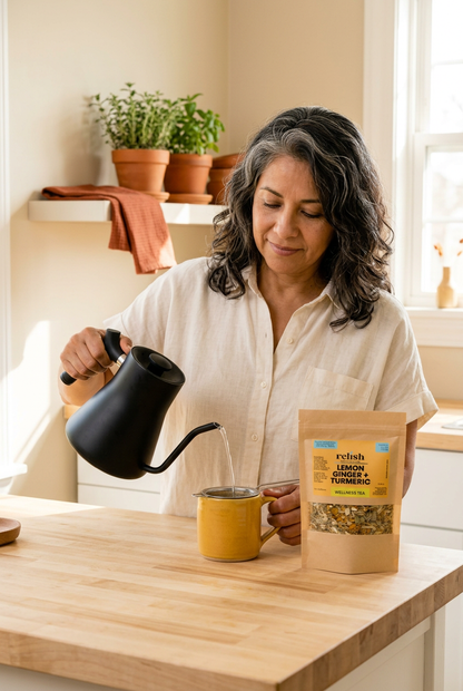 Woman at kitchen counter pouring Lemon Ginger Turmeric Tea Blend by Relish Market lifestyle kitchen pour