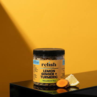 Lemon Ginger Turmeric Tea Blend by Relish Market jar close-up on a black stand and bold yellow background.