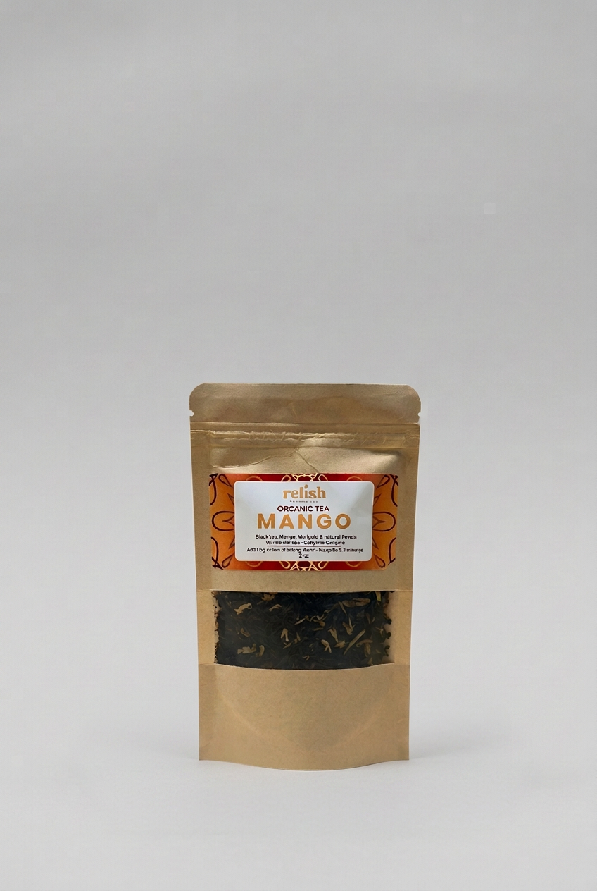 A stand-up kraft paper pouch of Relish Market's Organic Tea Mango, featuring a clear window that displays the dark tea leaves inside, set against a neutral light gray background.