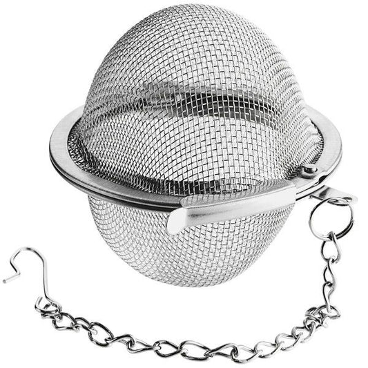 Metal tea ball with mesh design and chain on a white background