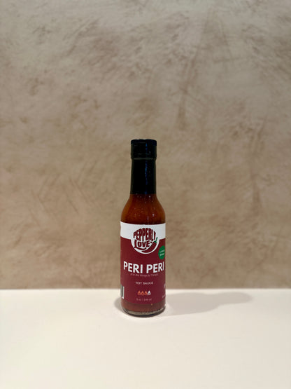 Peri Peri sauce bottle on a beige background