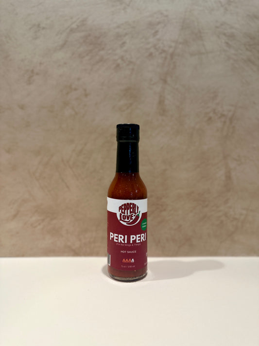 Peri Peri sauce bottle on a beige background