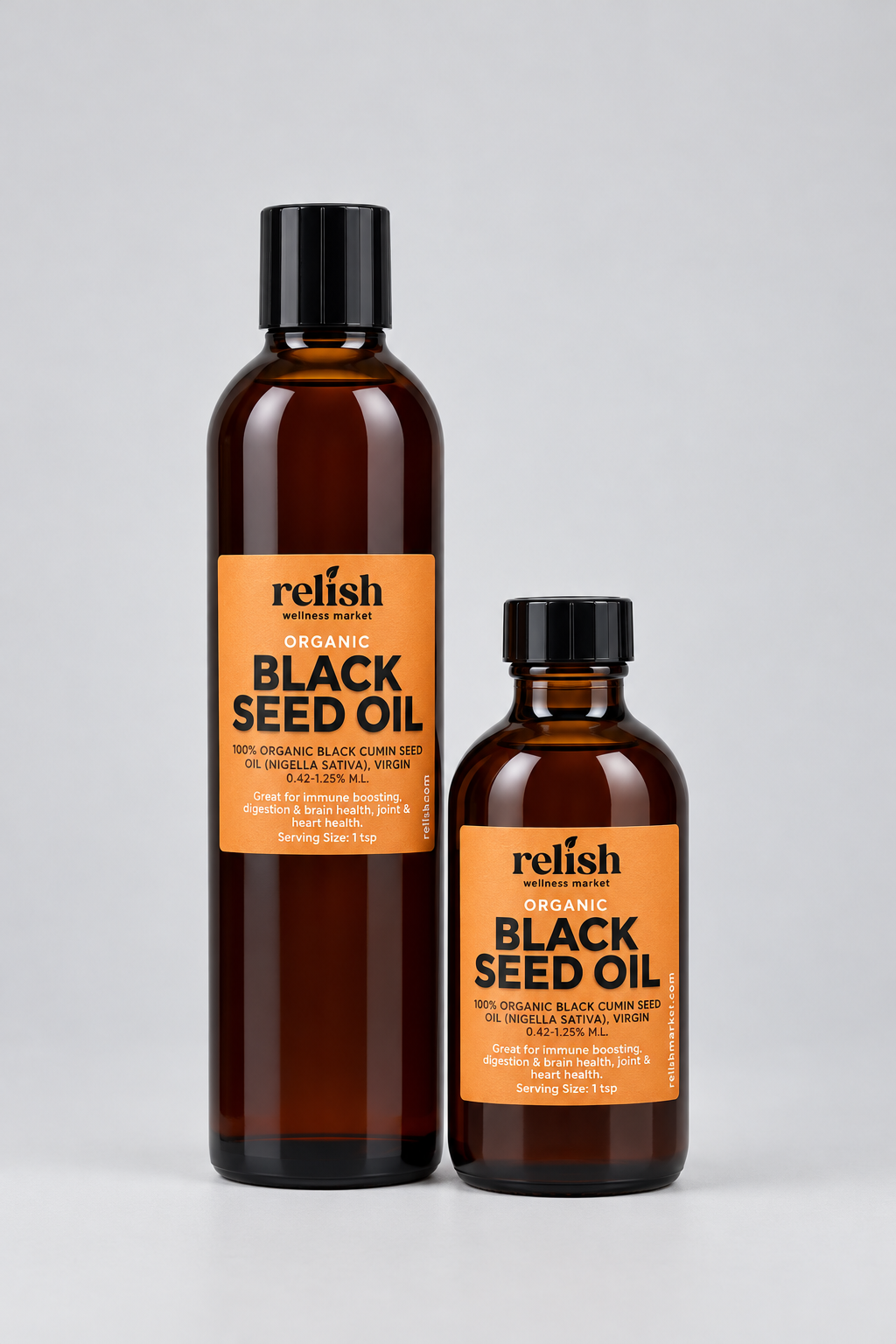 Two amber bottles of Relish Market's Organic Black Seed Oil with black caps and orange labels, shown on a light gray background.