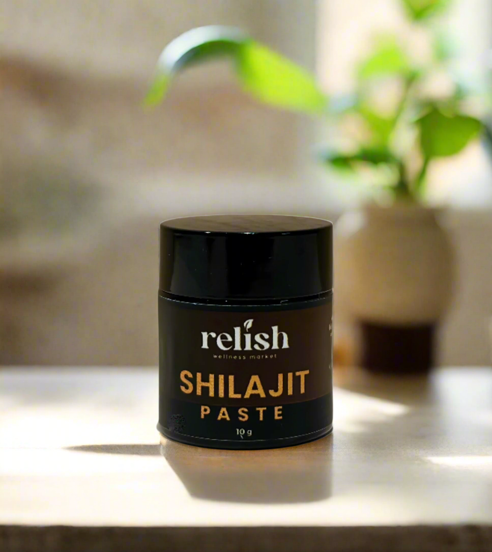 Shilajit Paste by Relish Market on a neutral countertop with a green houseplant in the background.