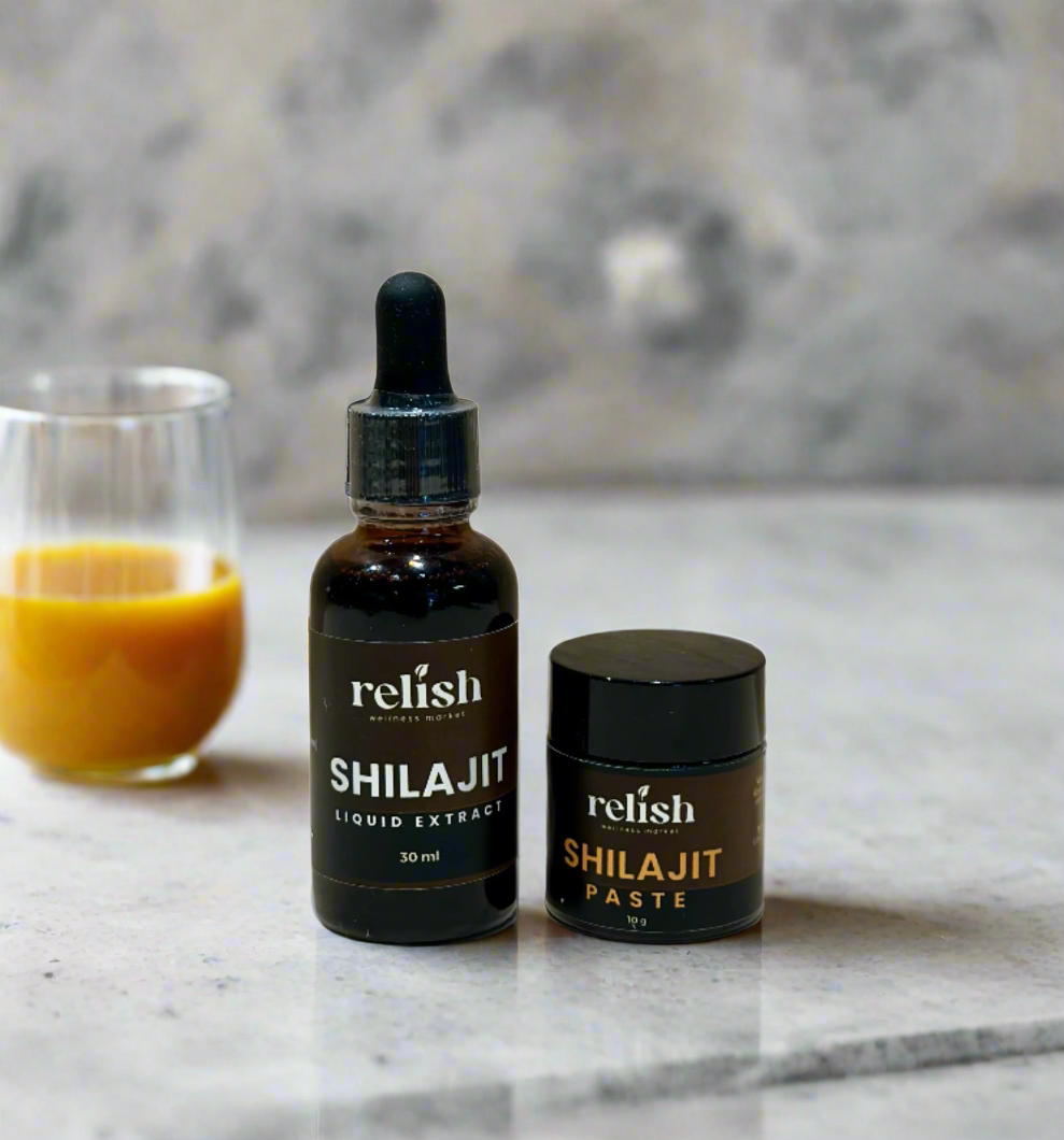 Shilajit Paste and Shilajit Drops by Relish Market on a marble counter with a glass of orange juice.