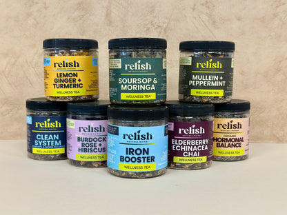 Collection of Relish wellness tea jars on a neutral background