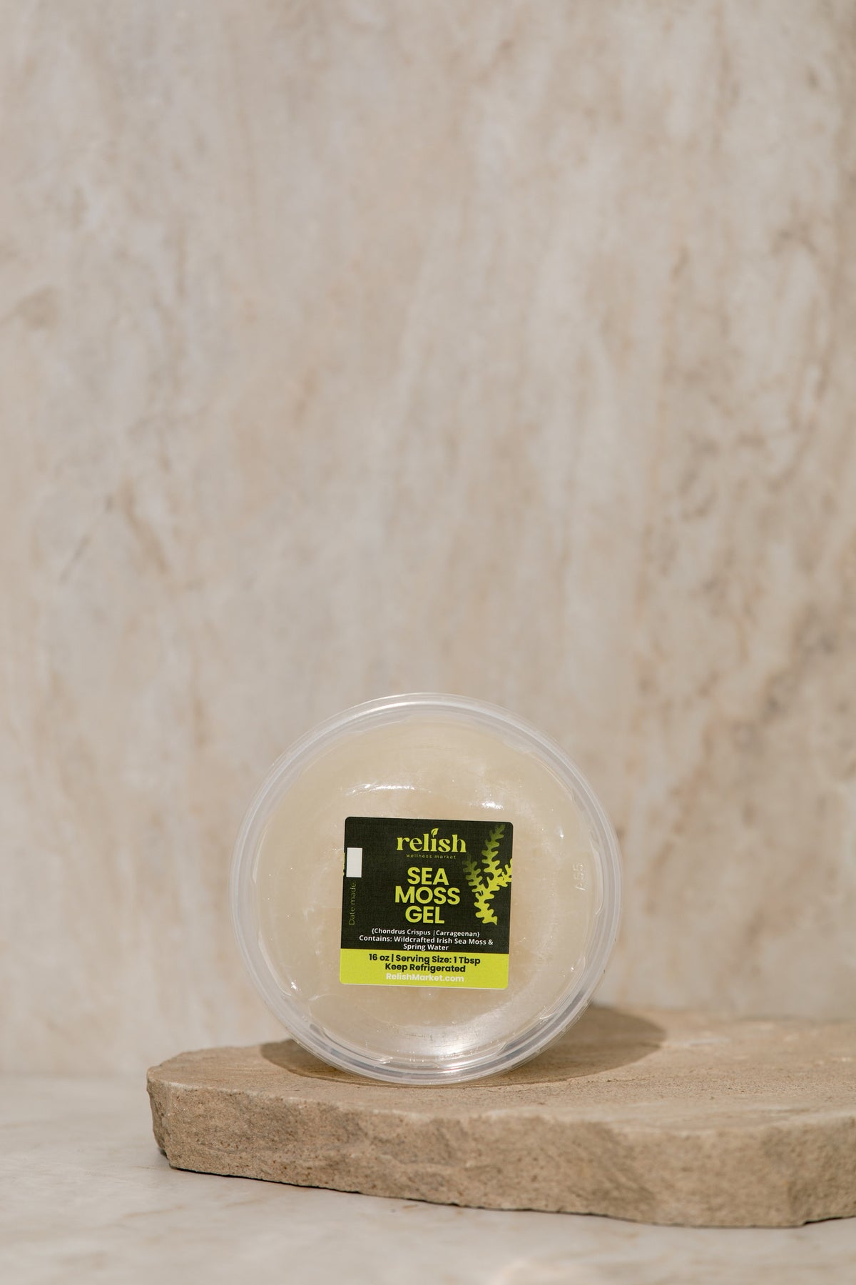 Relish Market Sea moss gel 16oz container on a stone slab and neutral background.