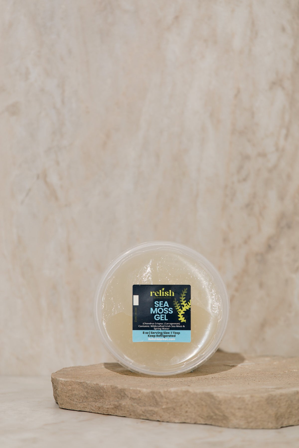 Relish Market Sea moss gel 8oz container on a stone slab and neutral background.