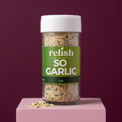 A jar of So Garlic Spice Blend by Relish Market on a light pink stand and purple background.